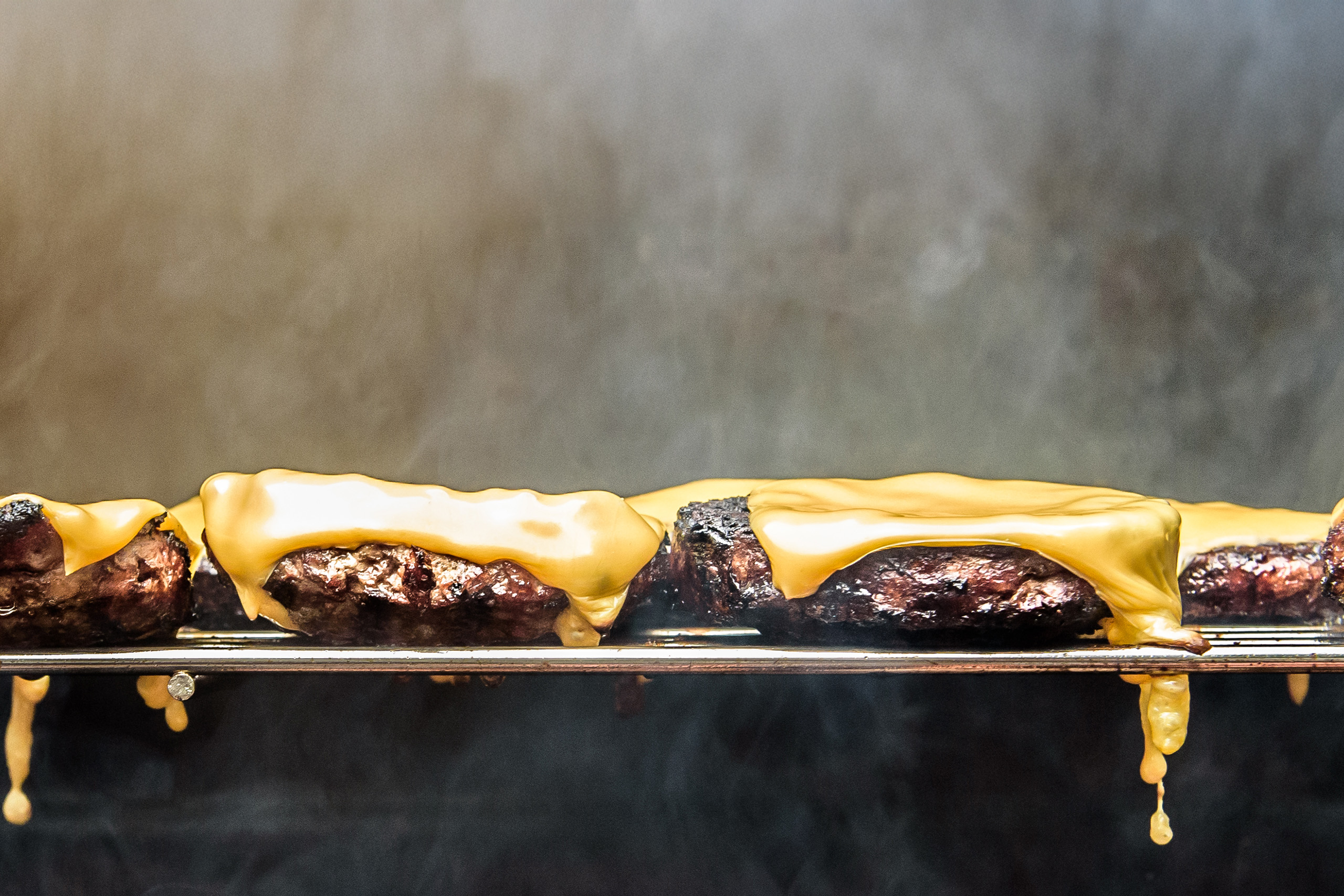 Hamburgers with cheese on grill