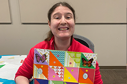 Life Program participant displaying self made quilt art