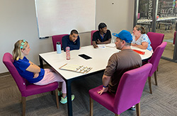 Group of adults reading at a table